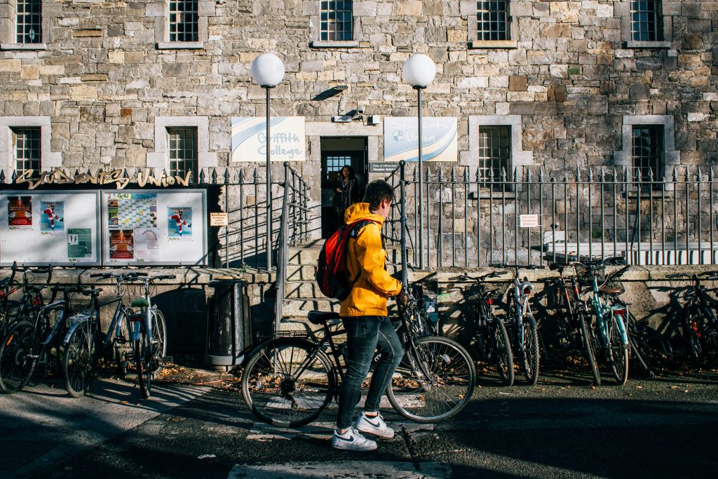 Boy in yellow jacked and backpack in front of Griffith College