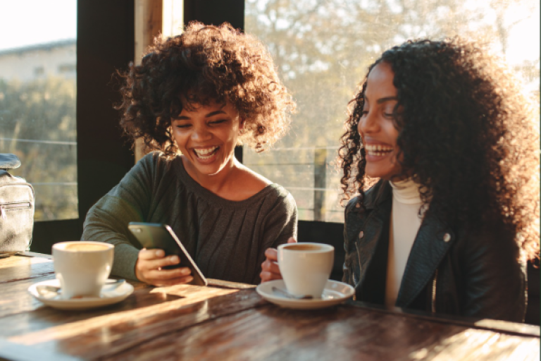 Two women enjoying a coffee on a sunny afternoon