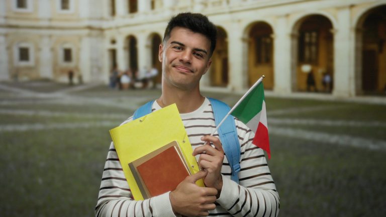 A young male student holing Italian Flag