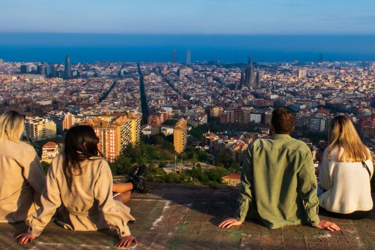 Students sitting above barcelona looking at the sea